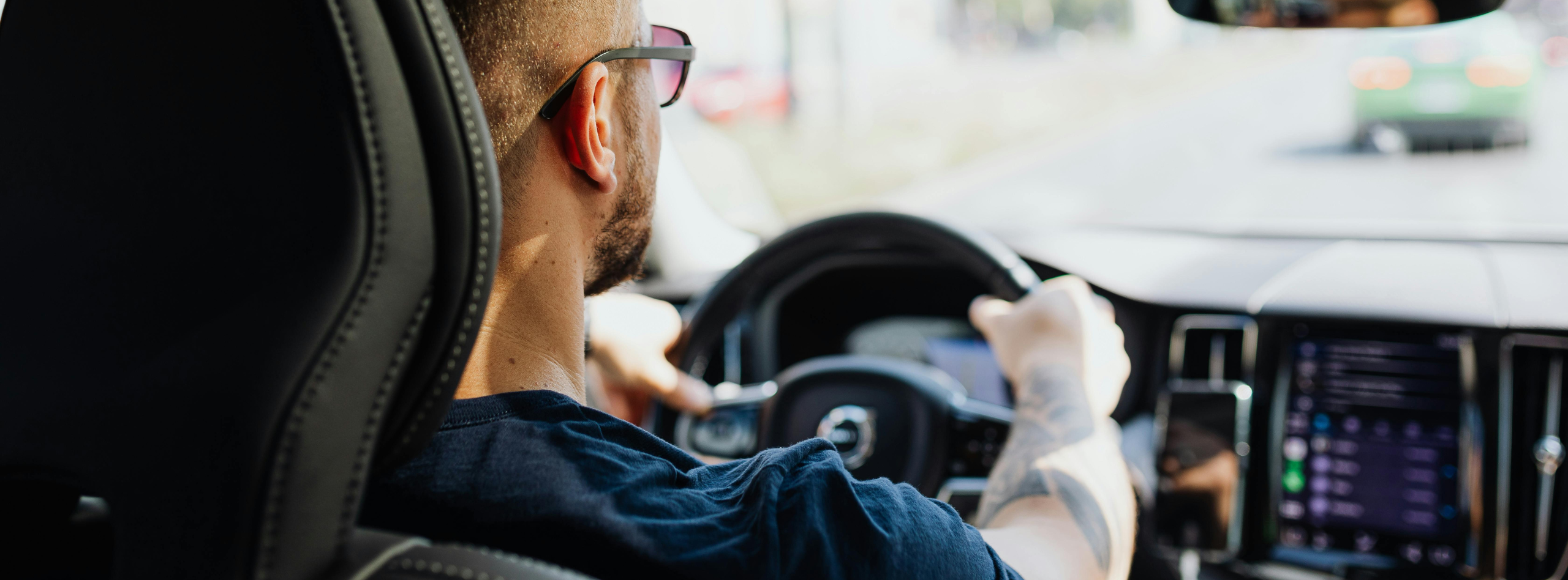 A driver behind the wheel of a car on a BC road, representing safe driving supported by BC car insurance from Westland Insurance.