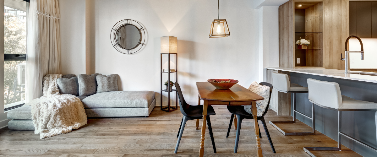 Interior of an apartment focusing on the living room and kitchen.