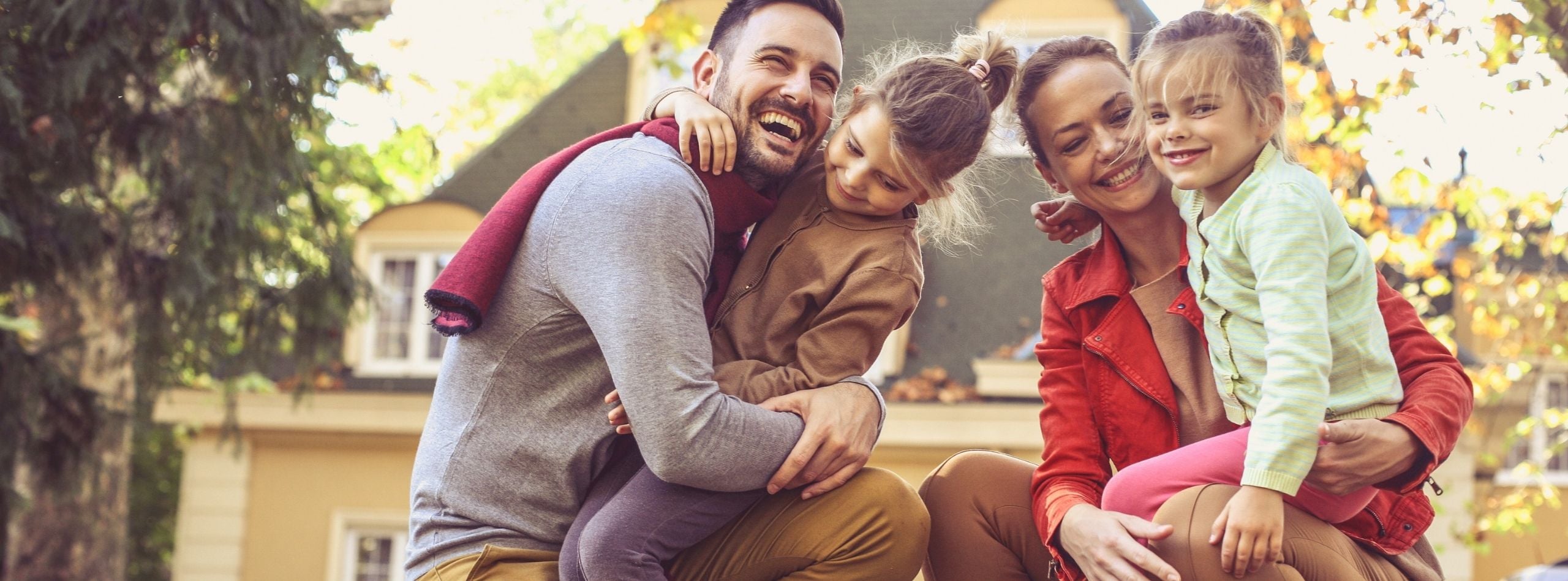 Family enjoying time together outside their home